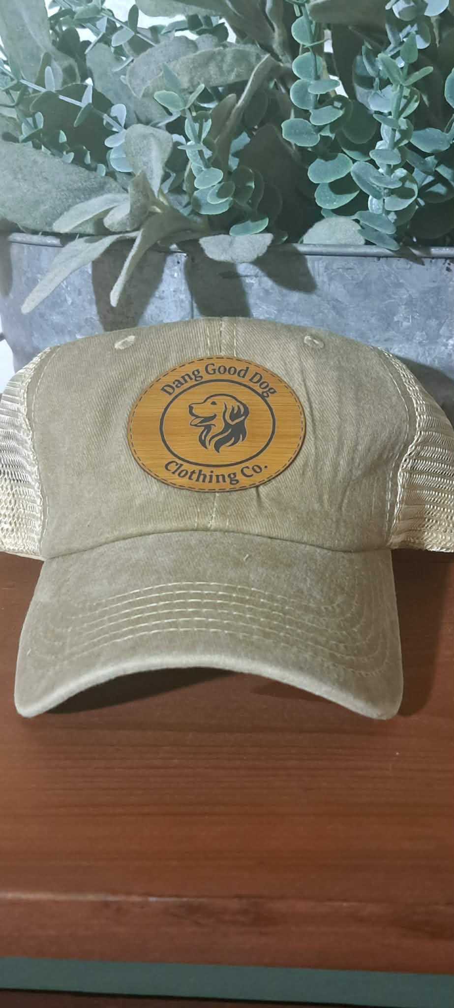Vintage tan mesh back hat with circle logo.